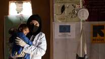  IRC counsellor Ruqia Moqtased comforts Shams Ullah during his malnutrition exam